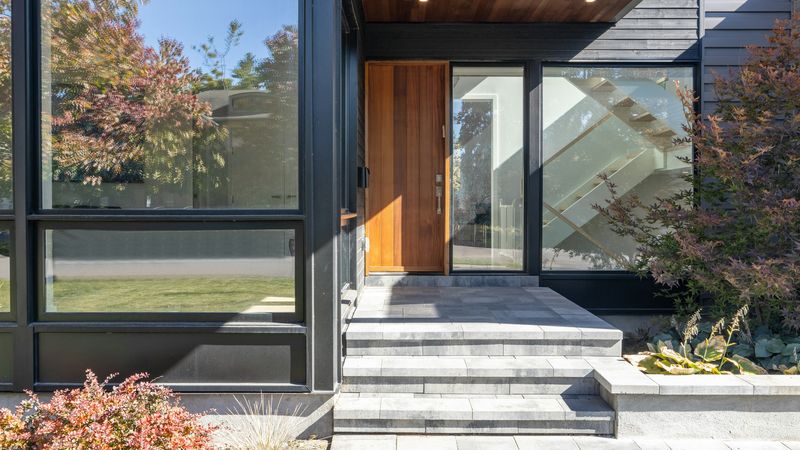 A front entry with a wood door and glass