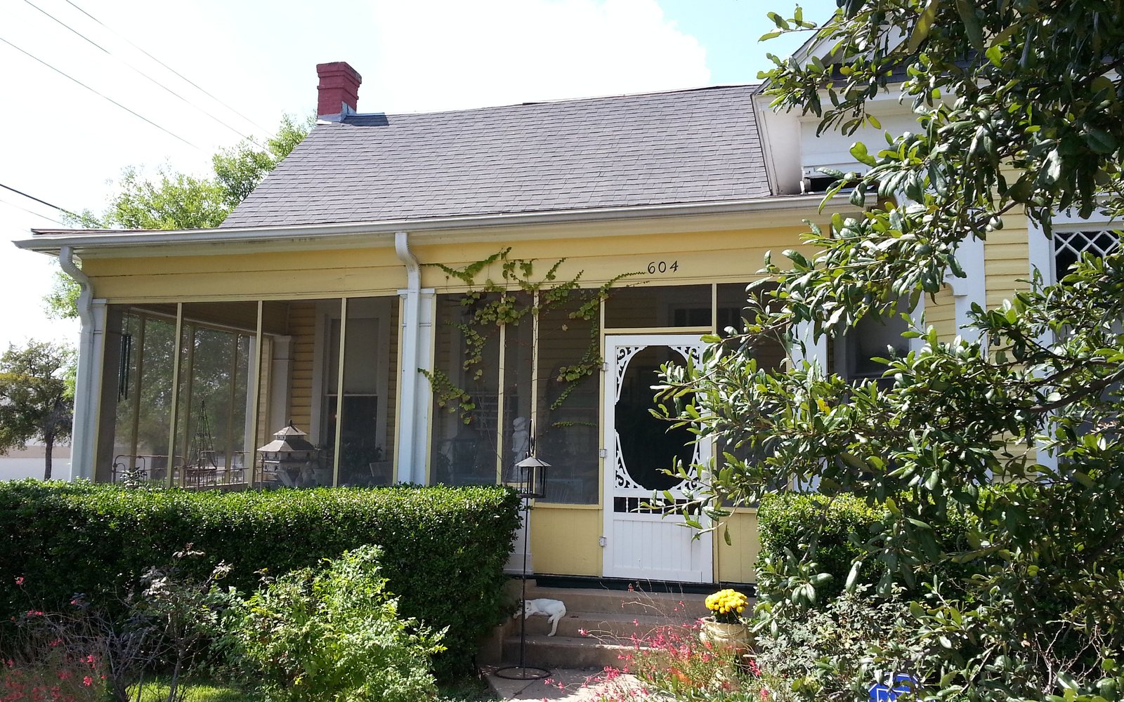 A historic house with a screened porch in Belton