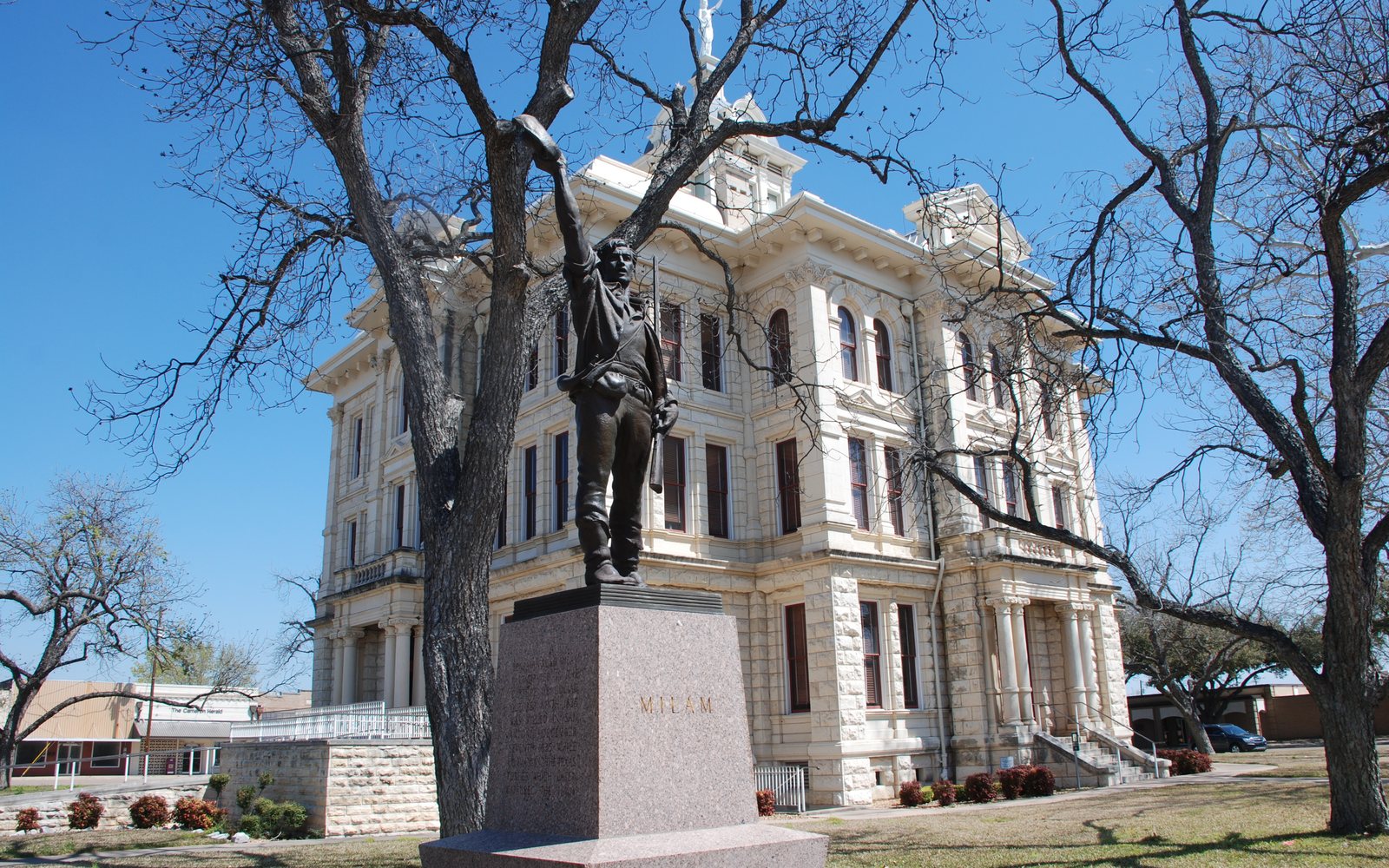 A bronze statue in front of the Milam County Courthouse