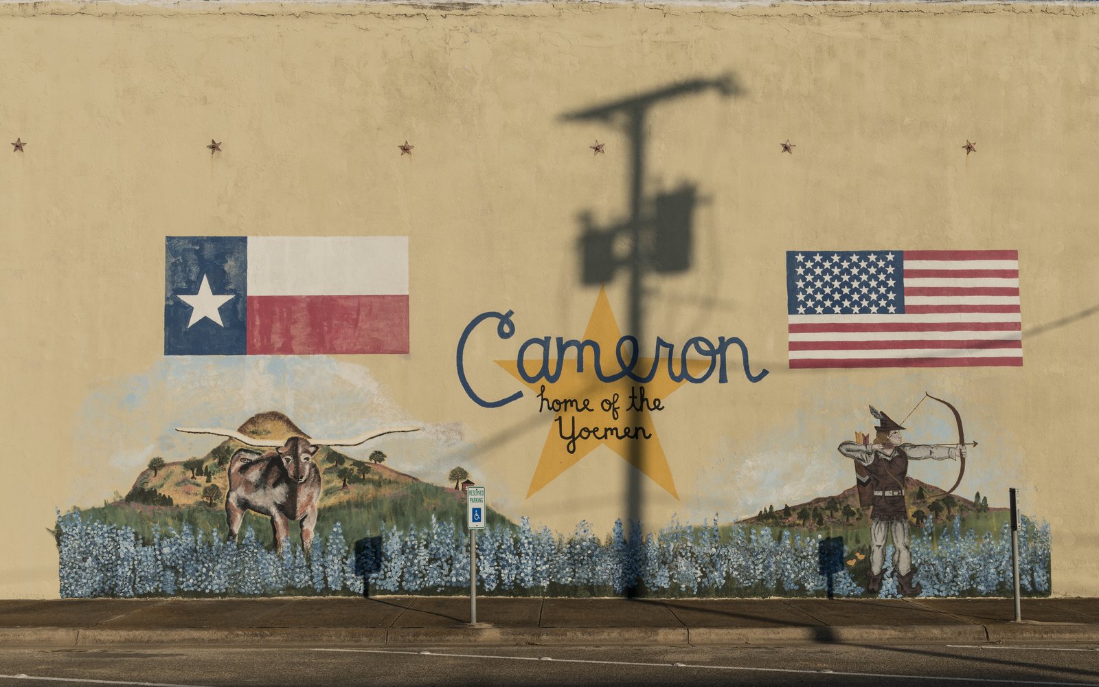A downtown mural with the Texas and United States flags and the word Cameron