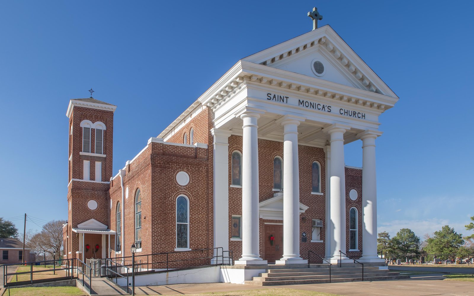 A brick church with white columns in Cameron