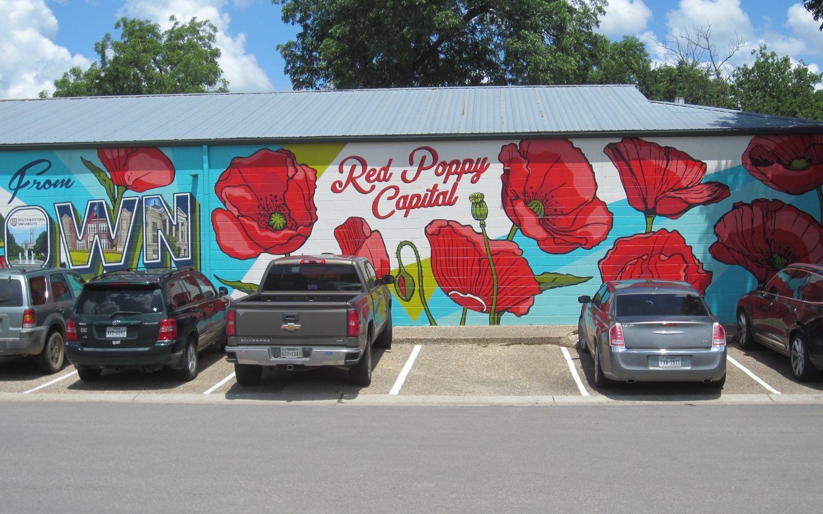 A mural of red poppies that reads Red Poppy Capital