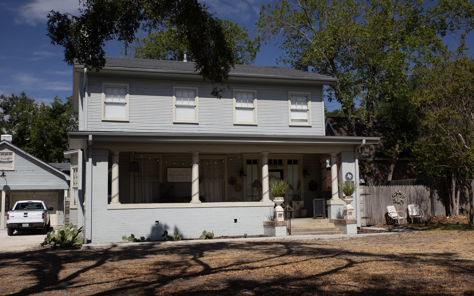 A two-story historic house with a wide front porch in Temple