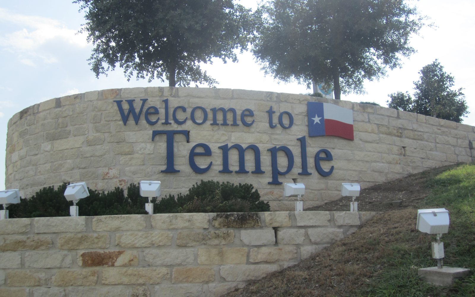 A stone sign that reads Welcome to Temple