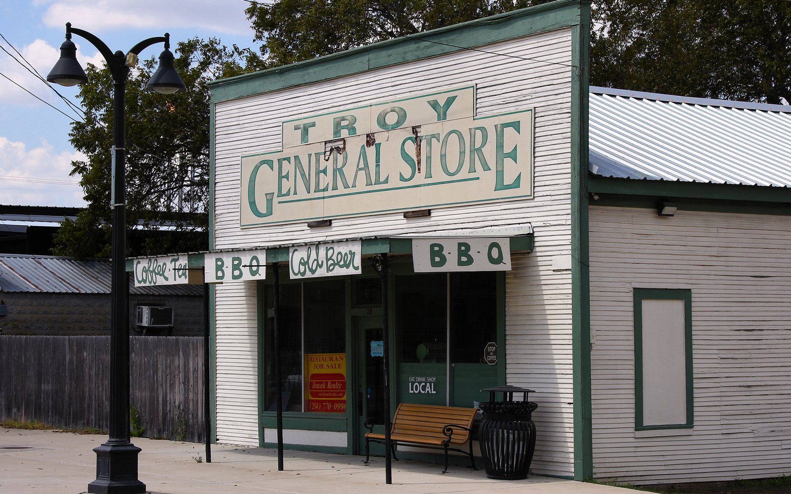 An old storefront with a Troy General Store sign