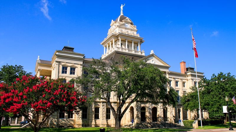The Bell County Courthouse in Belton with crape myrtles in bloom