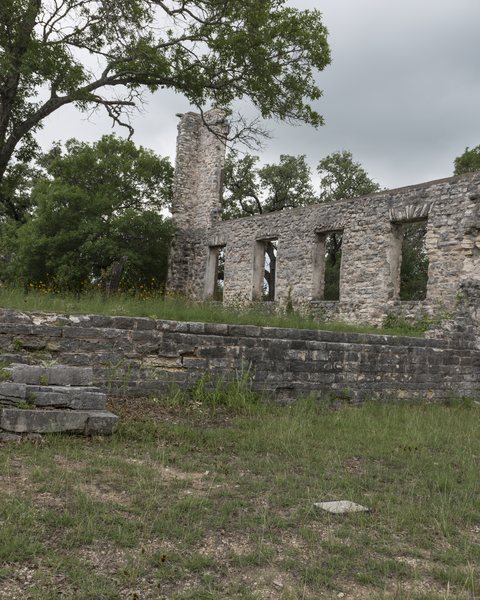 The stone ruins of Salado College under oak trees